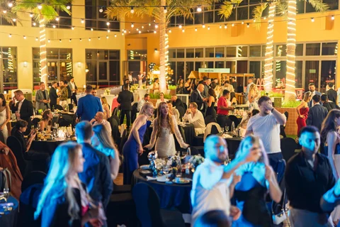 Crowded gala dinner warm lights