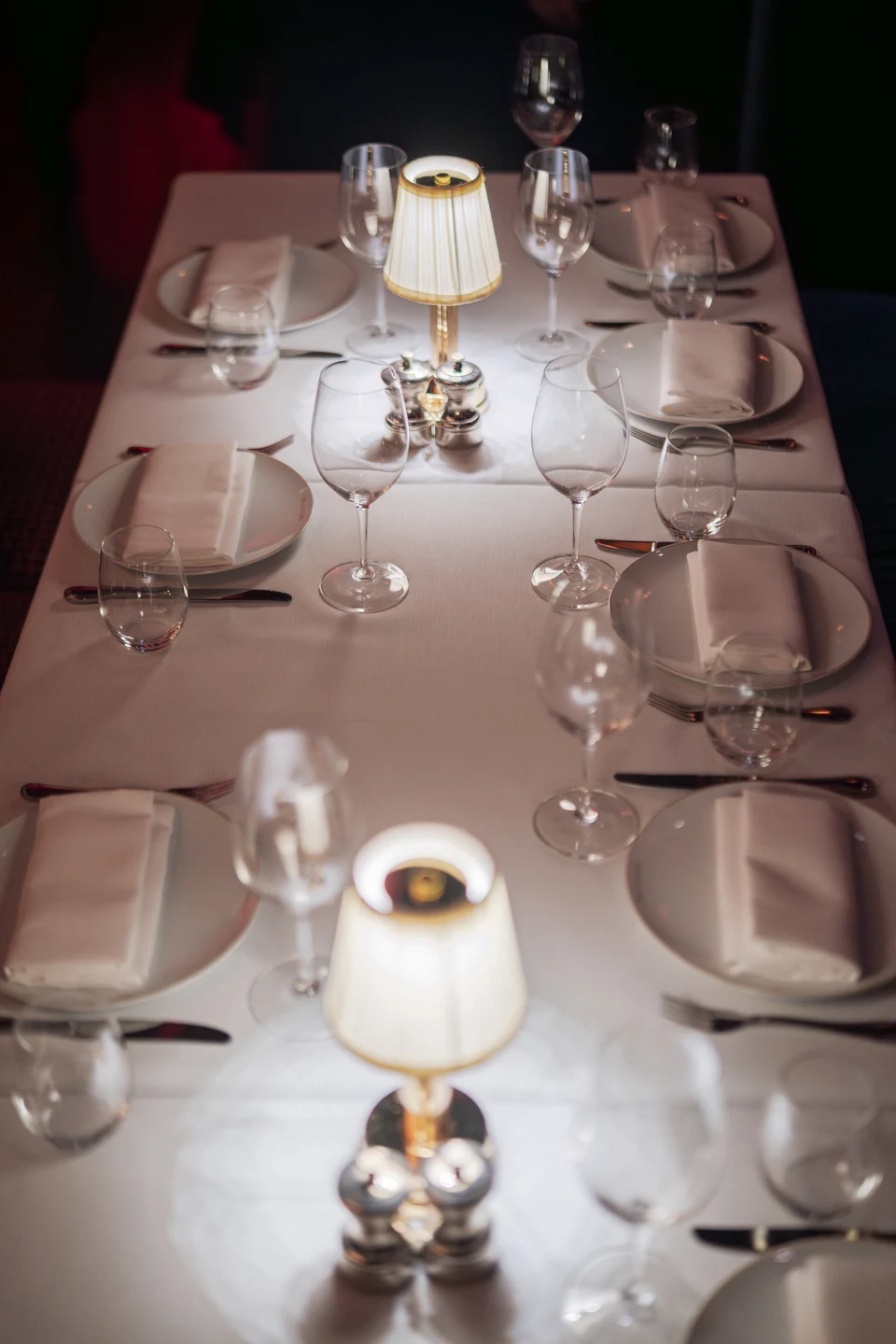 Long dining table with glowing lamps