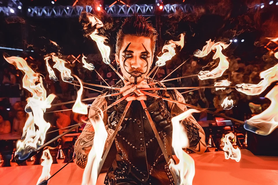 Performer framed by burning torches