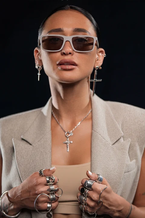 Sunglasses tailored jacket ringed hands