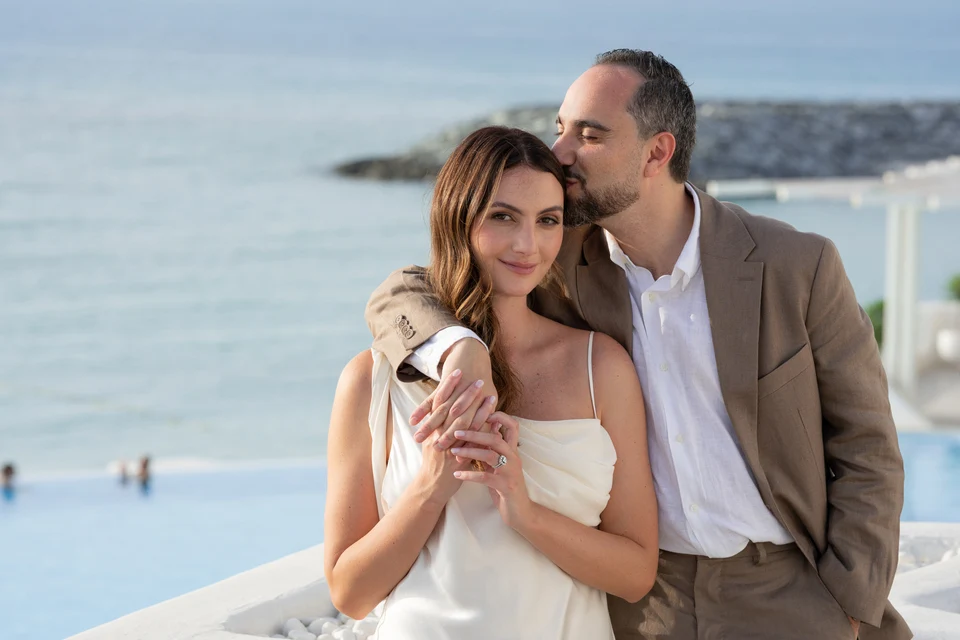 Seaside couple forehead kiss