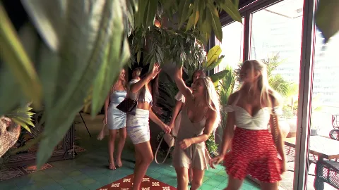 Guests arriving at a tropical-themed restaurant.