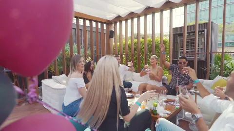 Guests gathered around an outdoor brunch table.