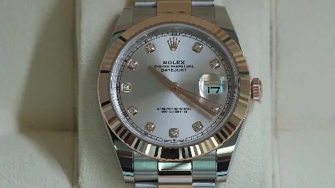 A close-up of a silver wristwatch dial.